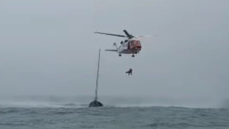 the helicopter rescues the unwell crew member