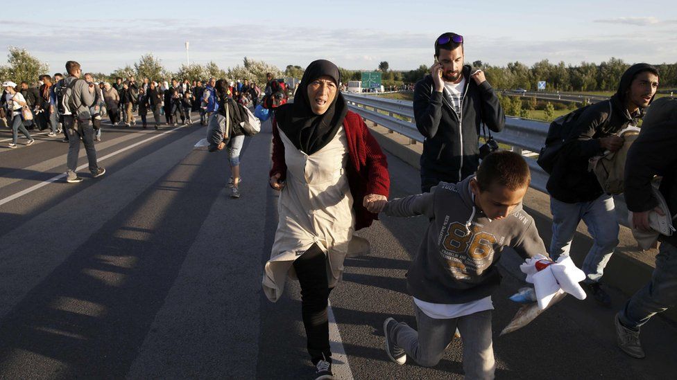 Migrants run along motorway to Budapest. 7 Sept 2015