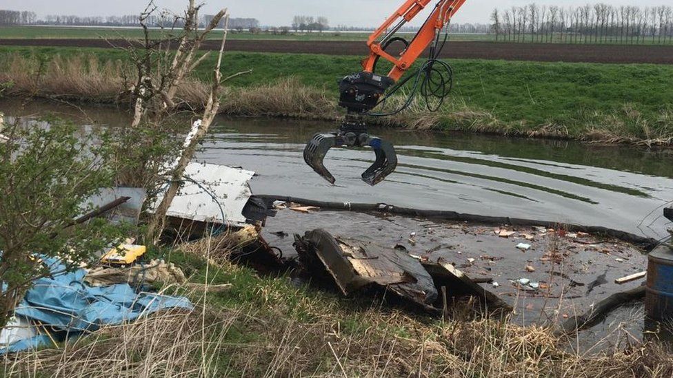 Wreckage of boat in river