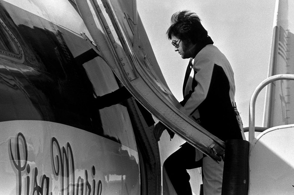Elvis Presley boarding his private jet, named the Lisa Marie, Elvis named his private jet after his beloved daughter.