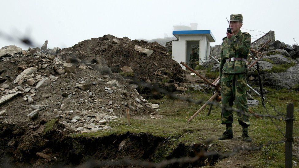 In this photograph taken on July 10, 2008, a Chinese soldier stands guard on the Chinese side of the ancient Nathu La border crossing between India and China.