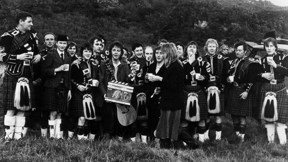 Denny Laine, Paul McCartney and Linda McCartney with the Campbeltown pipe band during the filming of the video