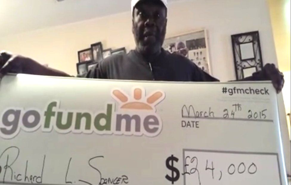 Richard L Spencer receives his cheque