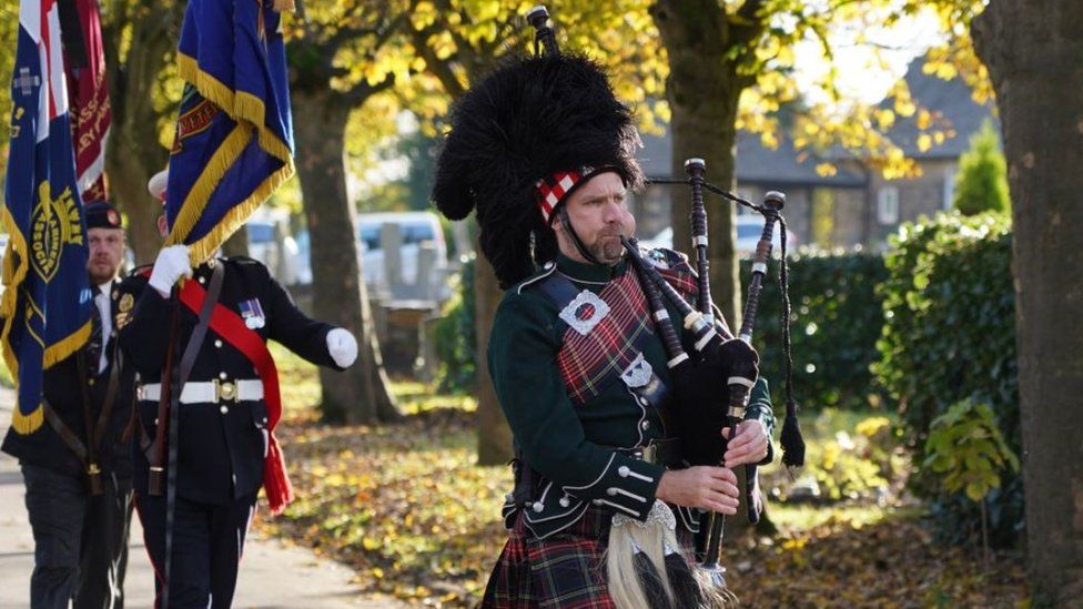 A piper and flagbearers followed Cyril Elliott's coffin to Shiregreen Cemetery