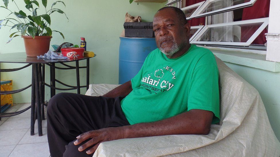 Sylvester Brown sits on the porch of his home