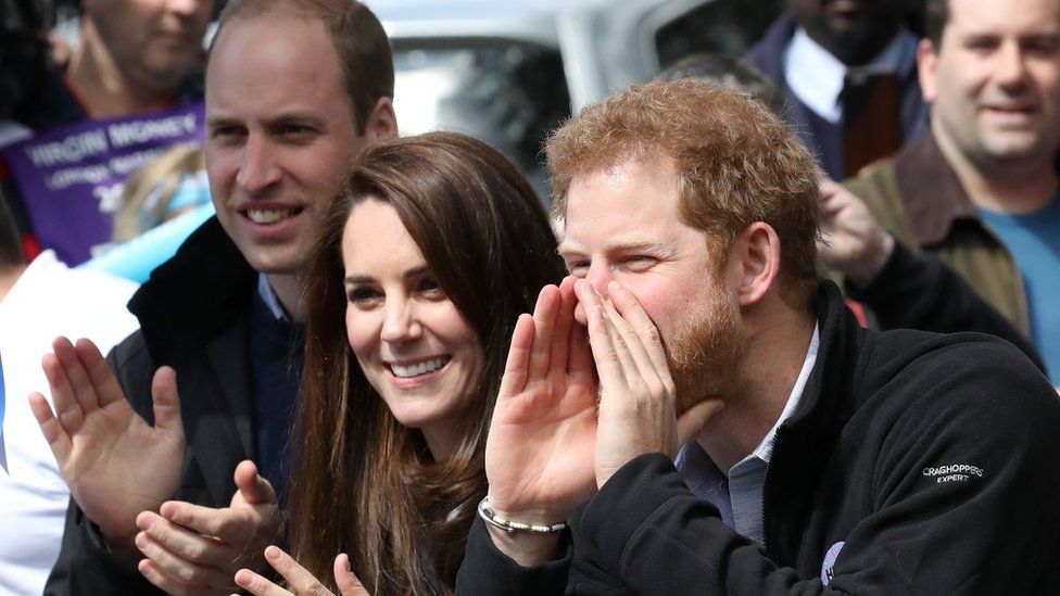 Prince William, Catherine, Duchess of Cambridge, and Prince Harry cheering