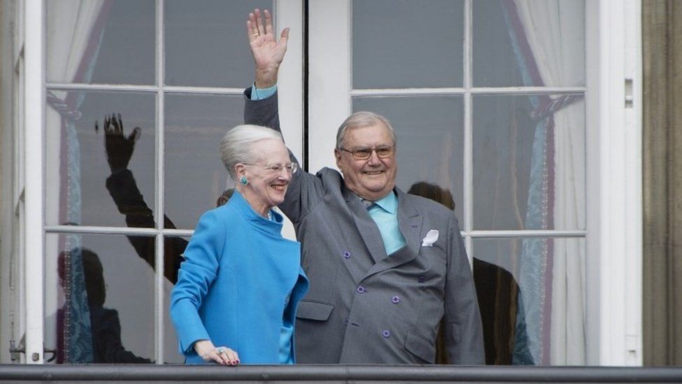 Denmark's Queen Margrethe and Prince Henrik wave from a balcony