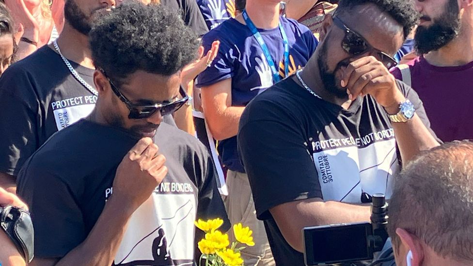 Grieving relatives and survivors from Eritrea at a memorial in Lampedusa, Italy - 3 October 2023