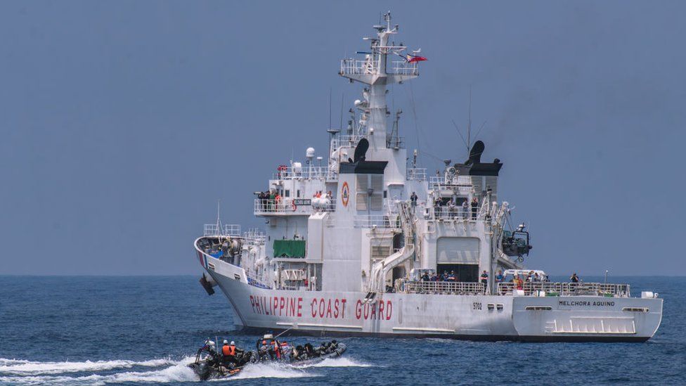 Members of the Philippine Coast Guard take part in a simulation during a trilateral maritime exercise with Japan and US coast guard on June 6, 2023, 15 nautical miles off the coast of Bataan province, western Philippines.