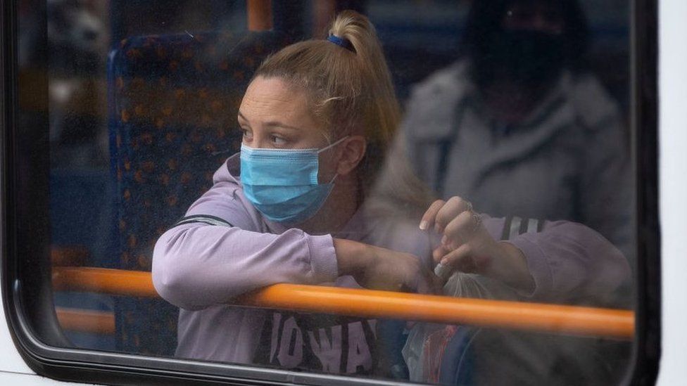 Woman on bus with face mask on