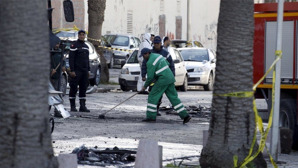 A sanitary service worker cleans the scene of a suicide bomb attack in Tunis