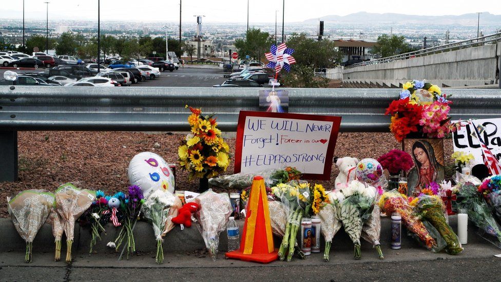 Signs and flowers left at a site nearby to where the shooting took place