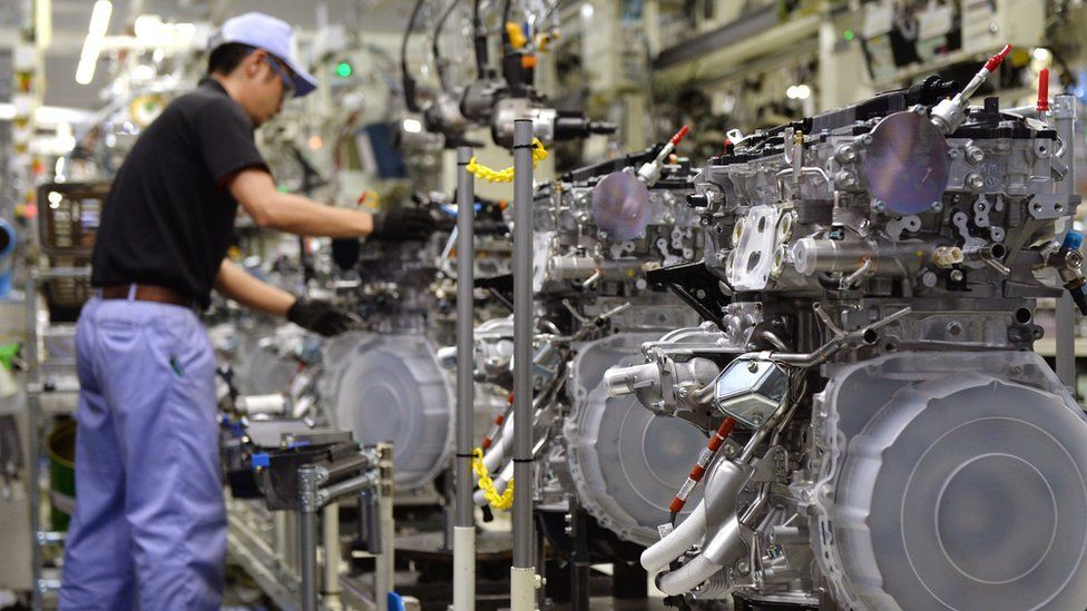 An employee of Toyota Motor's subsidiary Toyota Motor Kyushu assembles a new 2-litre gasoline turbo engine