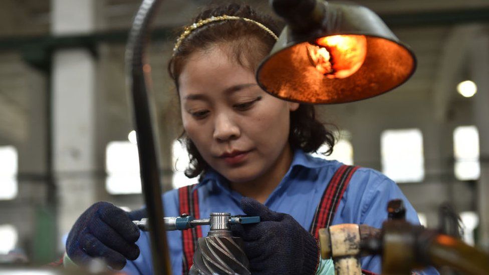 A woman working at a gear factory in Taizhou, East China's Jiangsu province.