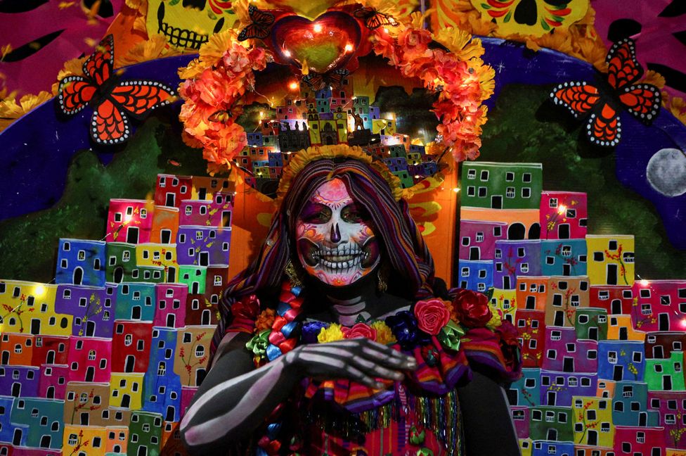 A participant dressed as the popular Mexican figure Catrina attends a parade, as part of the Day of the Dead celebrations, in Mexico City, Mexico 22 October, 2023