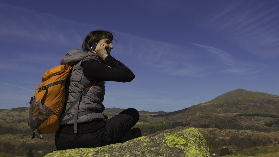 Using a phone in a remote location - stock image