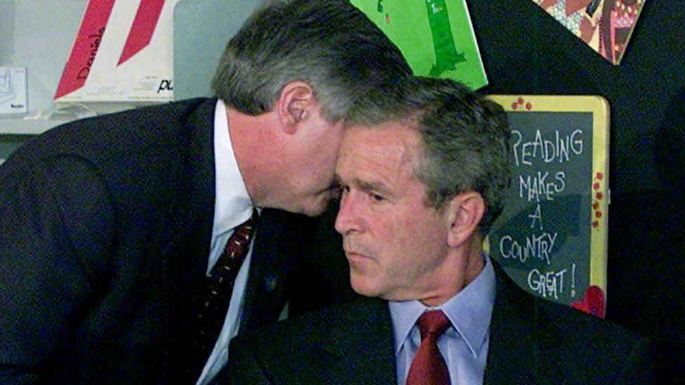 President George W. Bush is told of the twin tower attacks on Sept 11, 2001