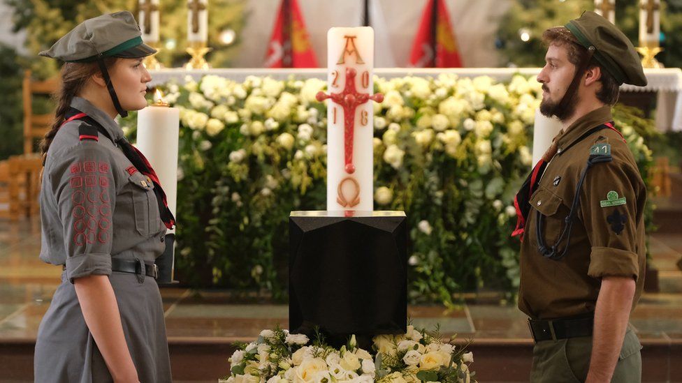 Scouts stand at the urn of Pawel Adamowicz prior to his funeral in St Mary's Church in Gdansk, Poland, 19 January 2019