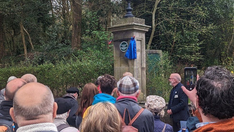 Crowds watch plaque unveiling