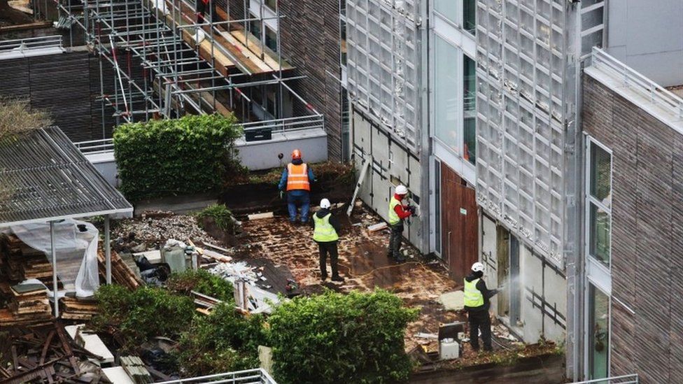 Contractors removing cladding