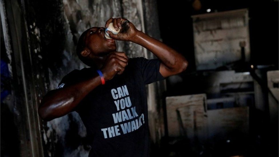 A boy eats a jar of baby food in a supermarket that was looted during protests against fuel price increases in Port-au-Prince, Haiti, July 8, 2018.