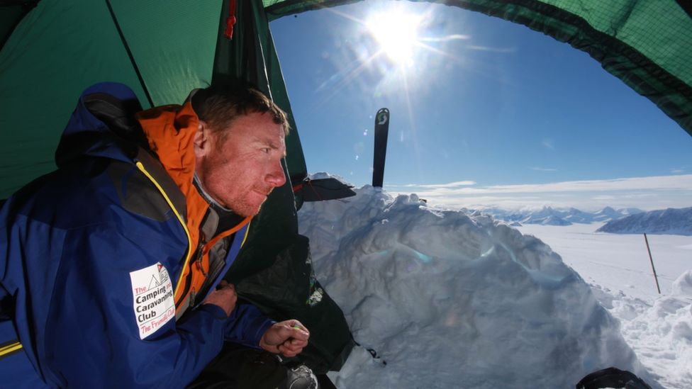 Paul Hart looks out from his tent onto a snow scene