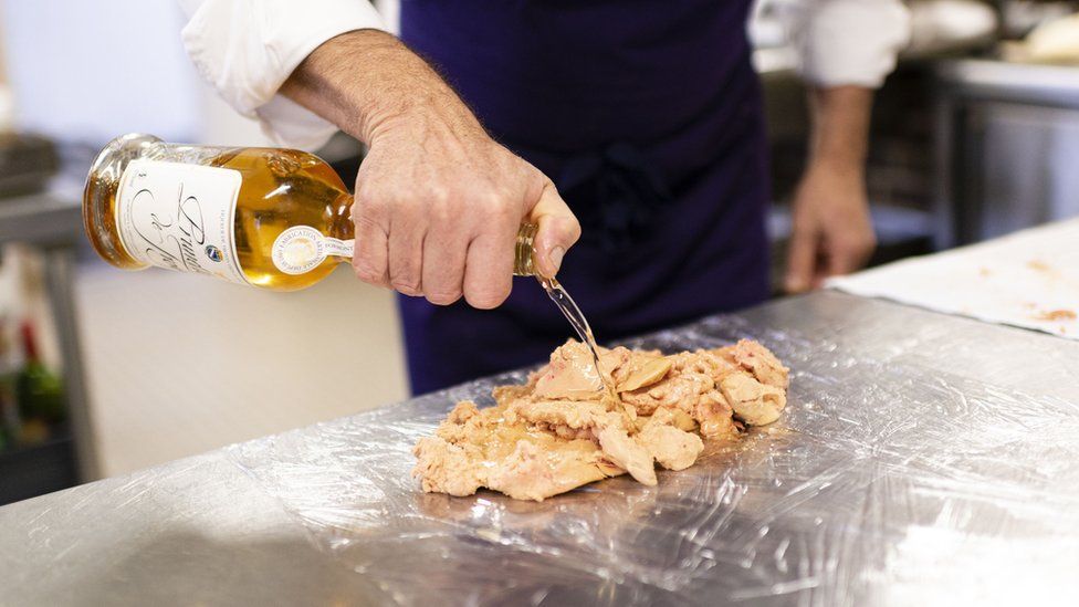 A chef prepares foie gras
