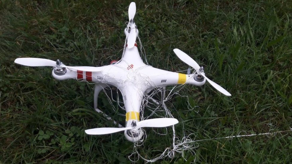 Drone on ground tangled in net
