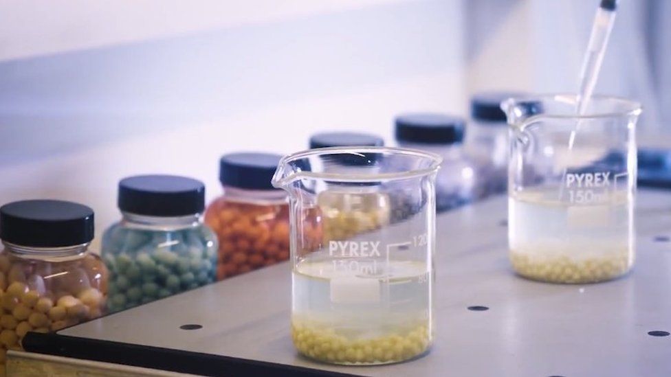 Pyrex beakers containing polymer balls in lab