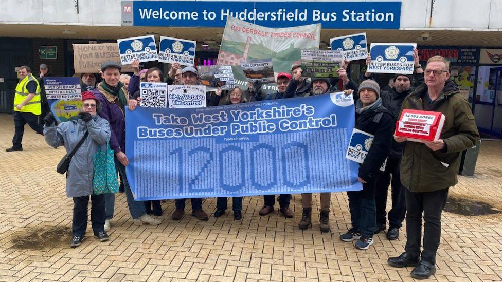 Bus campaigners outside Huddersfield bus station