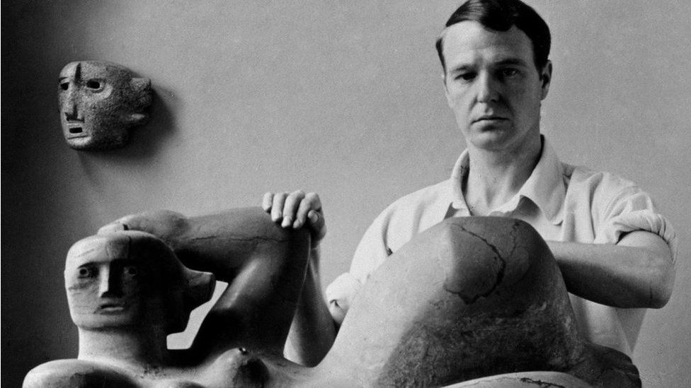 Henry Moore photographed with Reclining Figure