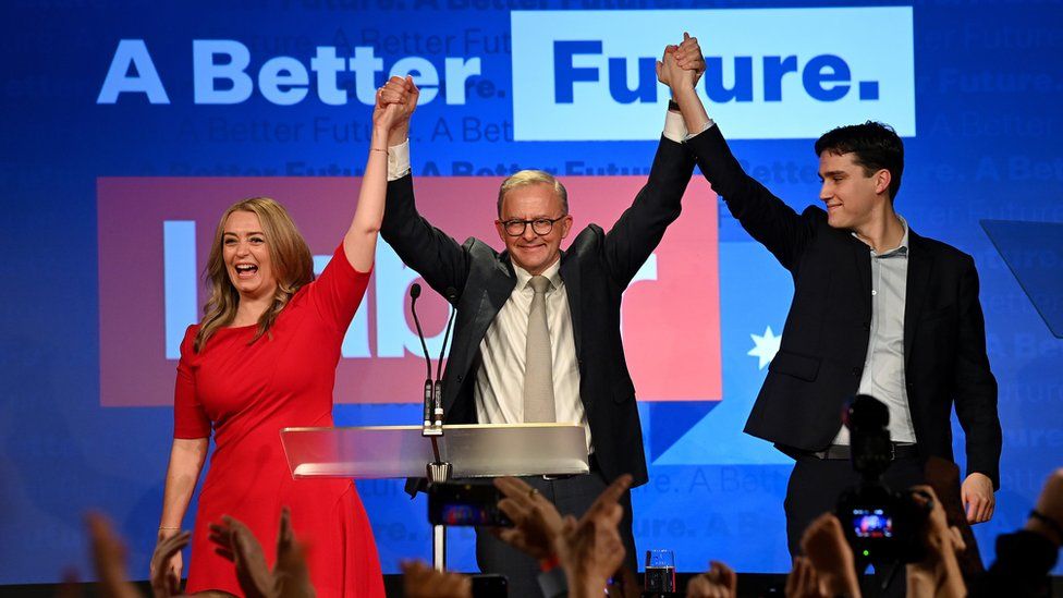 Anthony Albanese, who has been elected to be Australia's prime minister, is seen celebrating on stage with partner Jodie Haydon and son Nathan Albanese