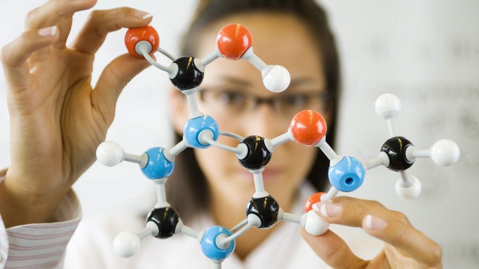 woman holding molecule model