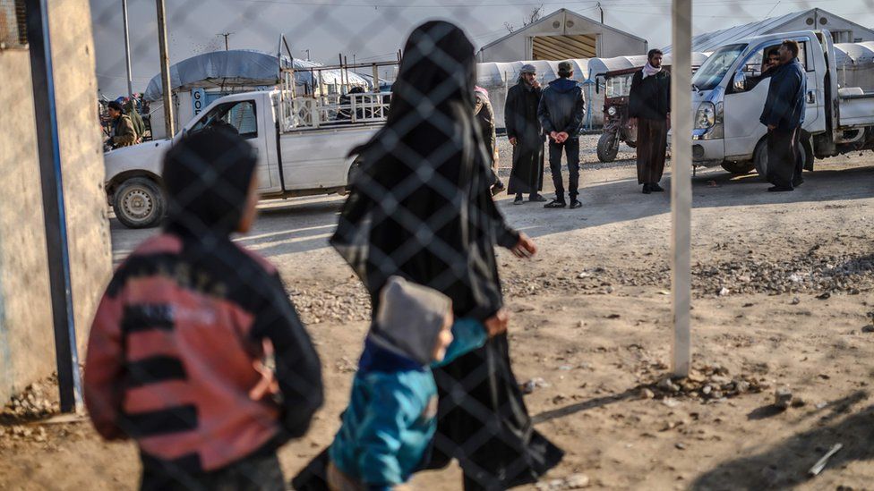 A detained female Islamic State member and her children at the al-Hol camp in north-eastern Syria (17 February 2019)