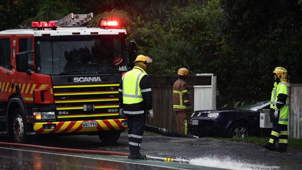 Firefighters pump water from a flooded home in Devonport, Auckland.