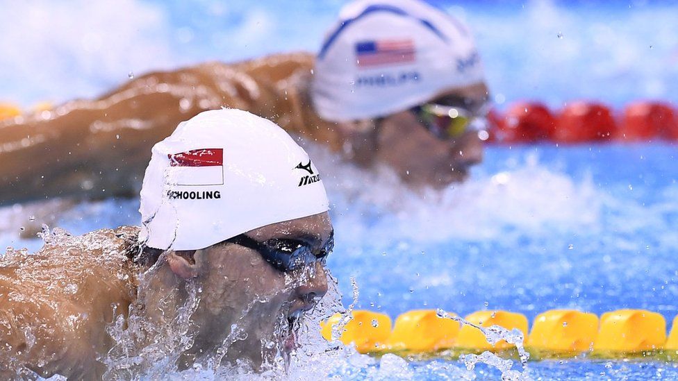 Singapore's Joseph Schooling and USA's Michael Phelps compete in a Men's 100m Butterfly heat