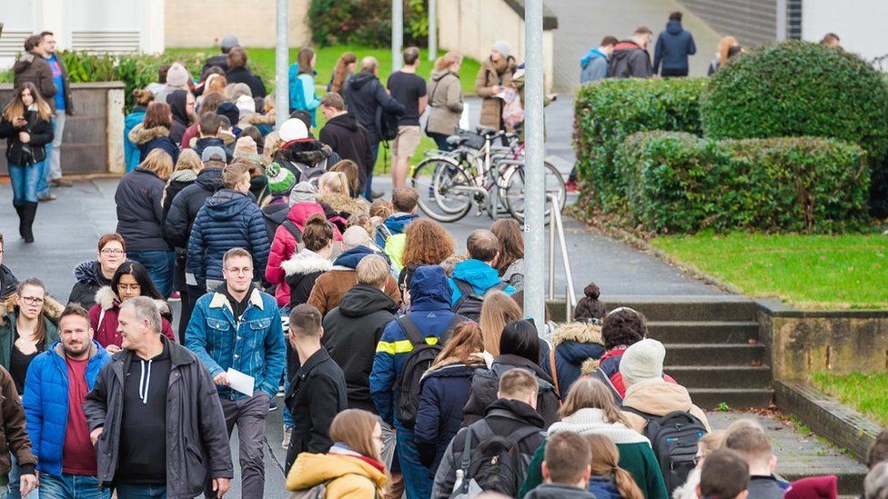 University students queue for a new email password