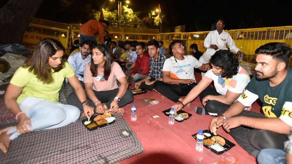 Wrestlers Vinesh Phogat, Sakshi Malik, Sangeeta Phogat and other wrestlers eating food (Dinner) during their protest against the Wrestling Federation of India at Jantar Mantar, on April 25, 2023 in New Delhi, India.