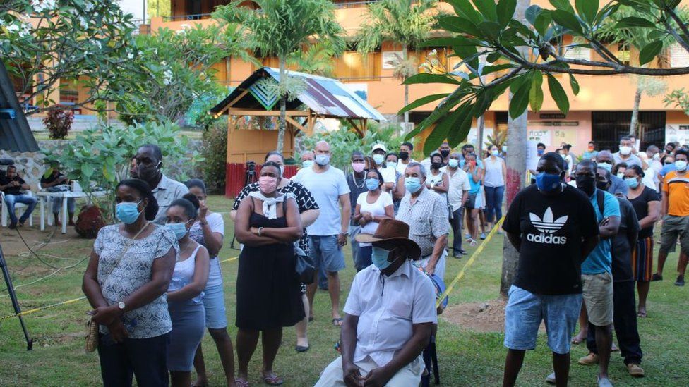 Voters queue at the Beau Vallo polling station, Mahe Island, on October 24, 2020 during the presidential and legislative elections
