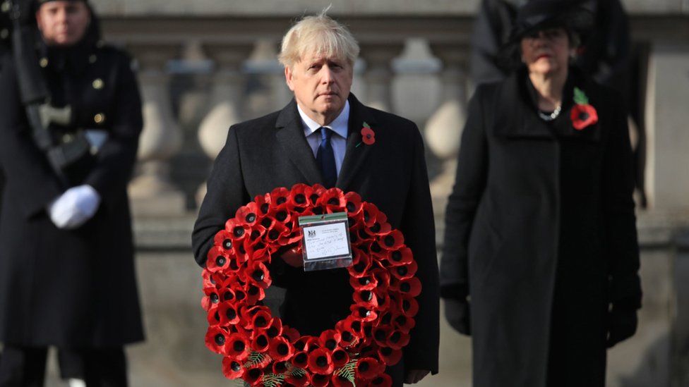 Boris Johnson holding a wreath