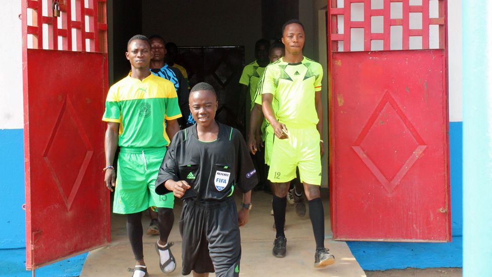 Isaac marches out to referee a game, wearing Howard Webb's shirt