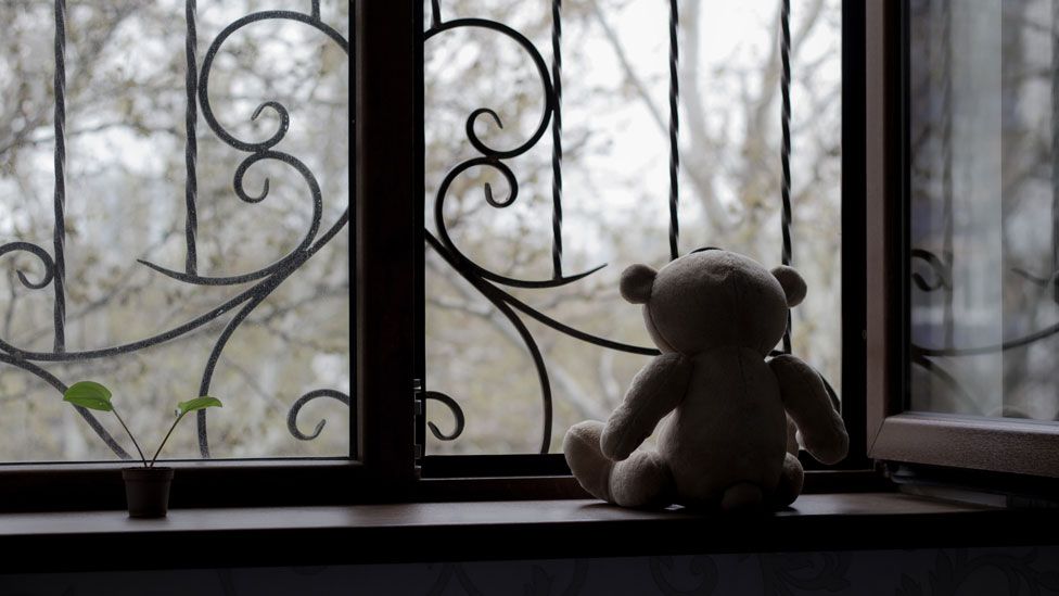 Teddy bear at window