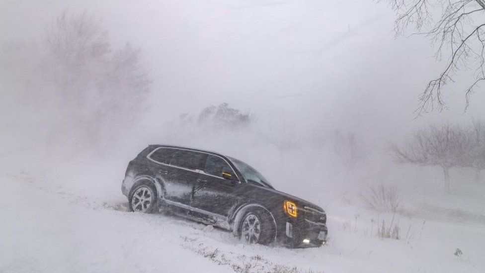 A car in a ditch during a winter storm near Wainfleet, Ontario province, Canada. Photo: 24 December 2022