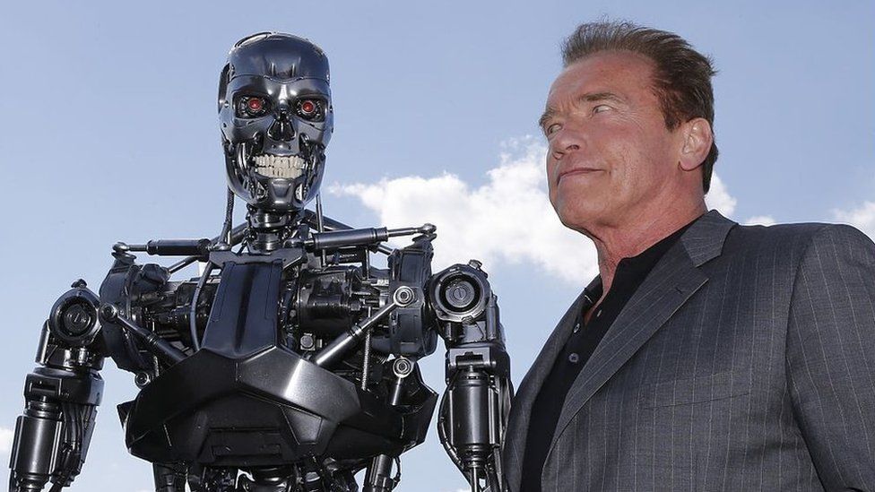 US actor and former governor of California Arnold Schwarzenegger poses with the Terminator animatronics robot