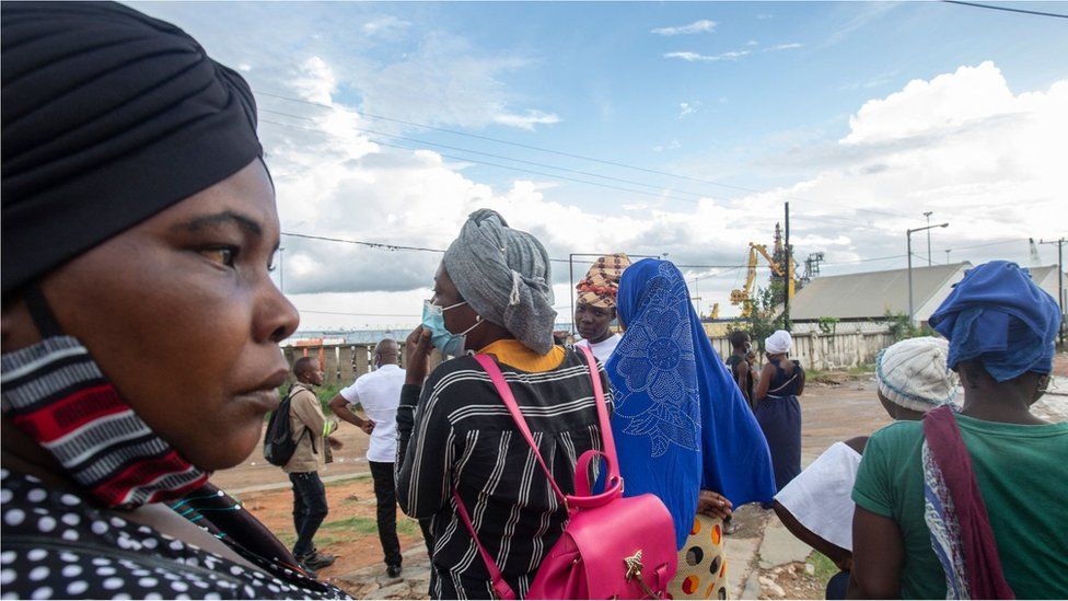 People wait on the outskirts of the seaport of Pemba on March 30, 2021 for the possible arrival of their families evacuated from the coasts of Afungi and Palma after the attack by armed forces against the city of Palma on March 24, 202