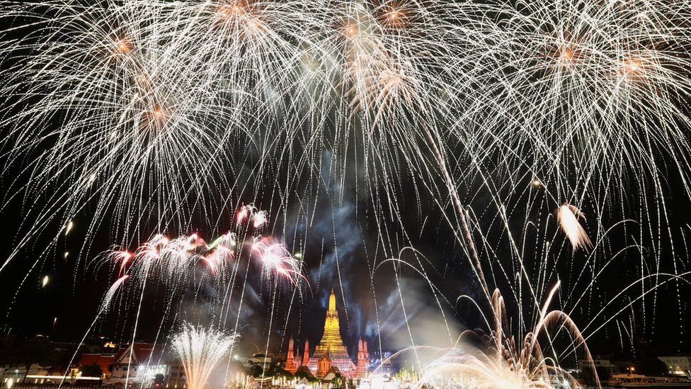 Fireworks exploded over the Chao Phraya River in Bangkok, Thailand as clocks struck midnight