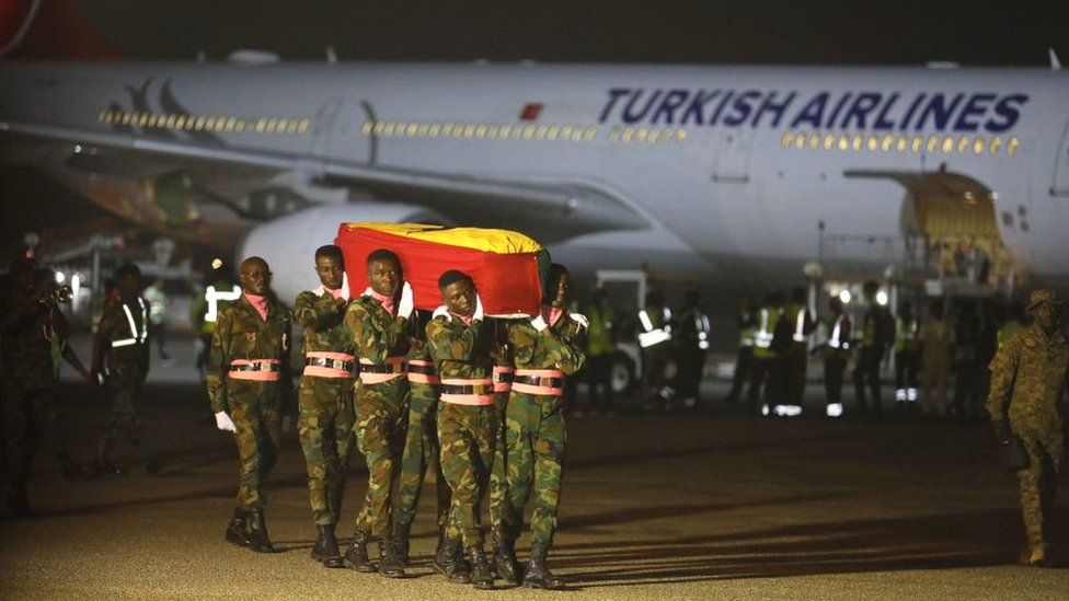 Atsu's coffin being carried by Ghanaian military from plane in Accra
