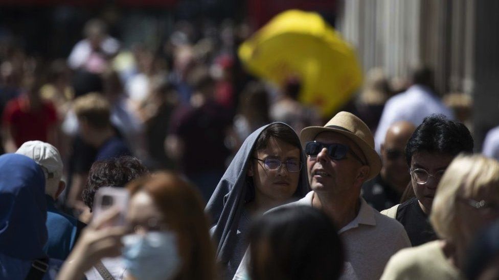 Street scene of people wearing sun protection