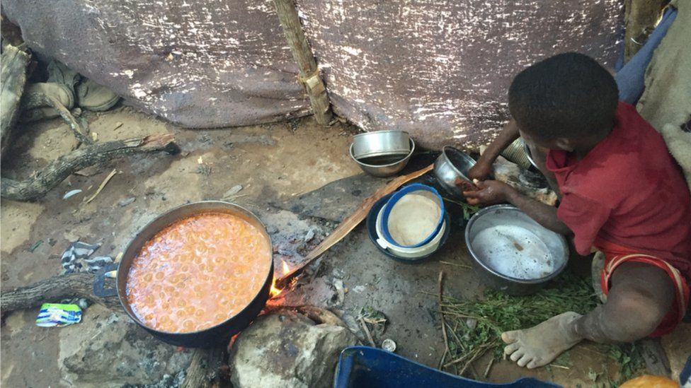One of Mr Giles children helps prepare food at Parc Cadeau