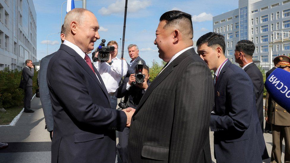 Kim Jong Un and Vladimir Putin shaking hands